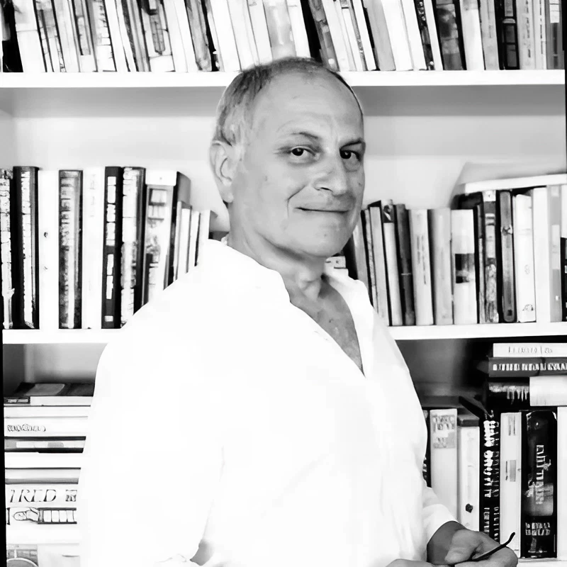 681a4fe2b9cc2_Profile Picture (1) A man standing in front of some books